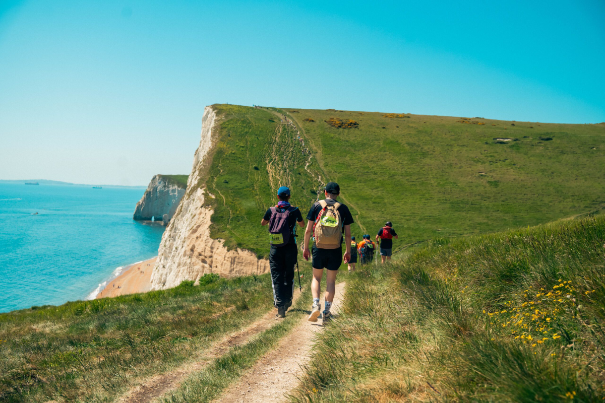 Jurassic Coast Ultra Challenge Participants Trekking Along The Coast Scaled